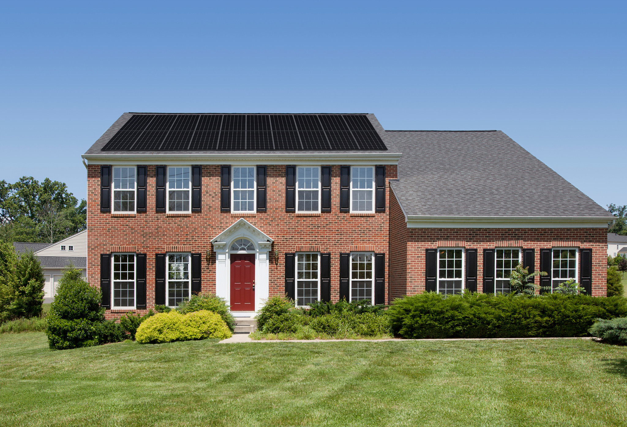 Brick colonial house with solar panels in Iowa