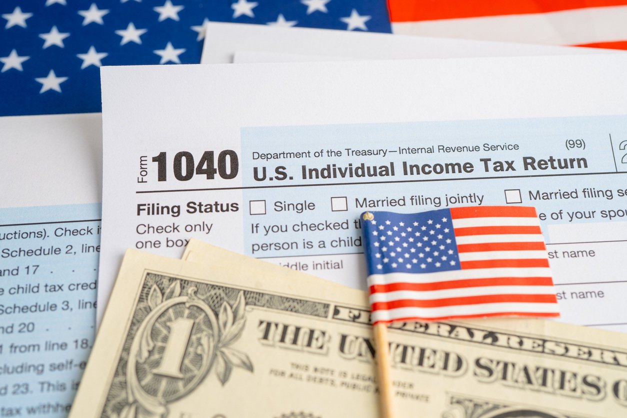 Iowa Solar Tax Credit - American Flag with Income Tax Forms and Cash